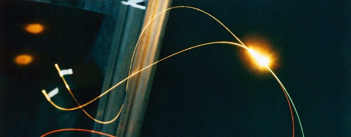 Glowing optical fibers against a dark background